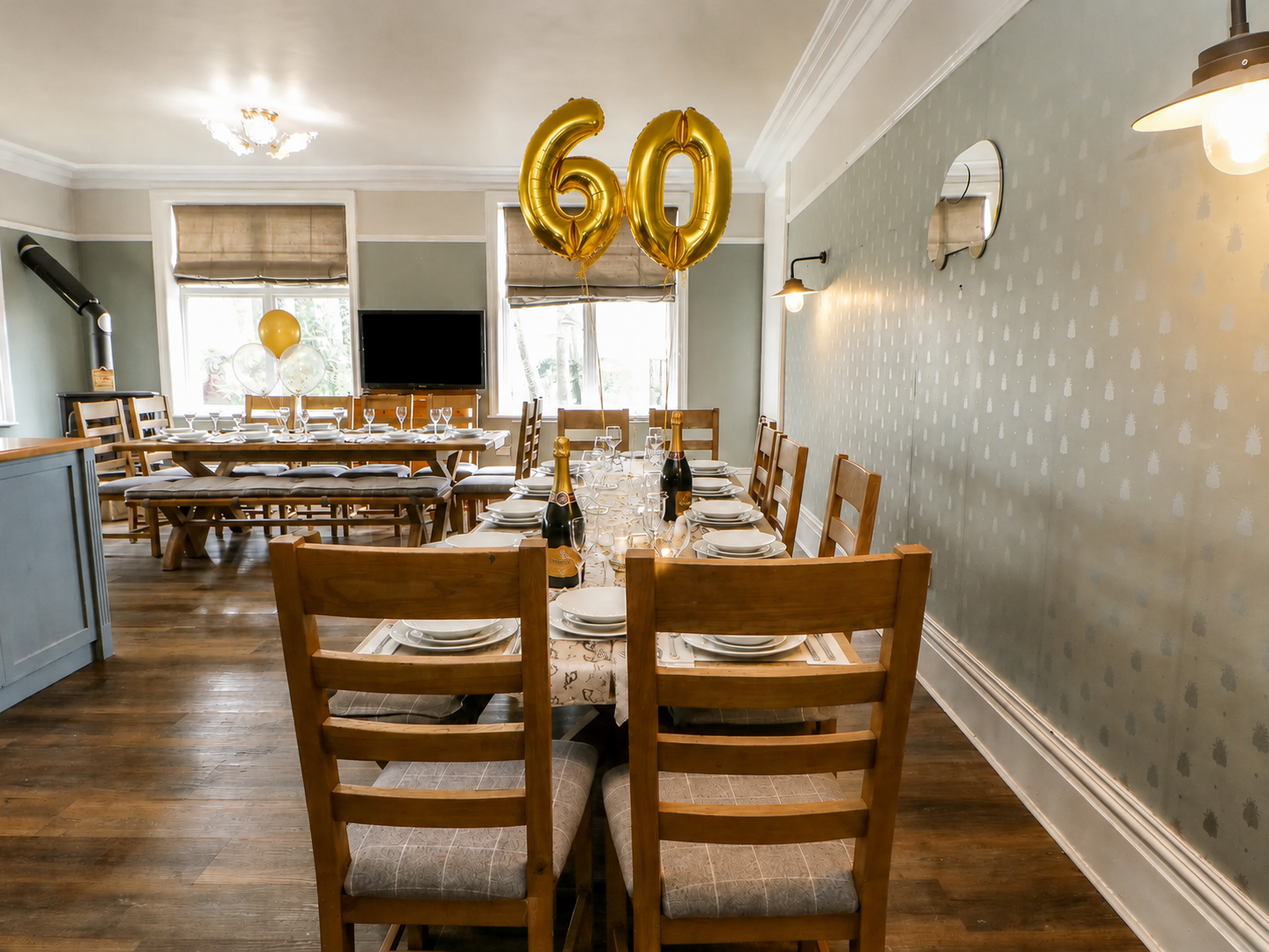 Celebration dining at Heather Brae with laid tables, champagne and gold balloons