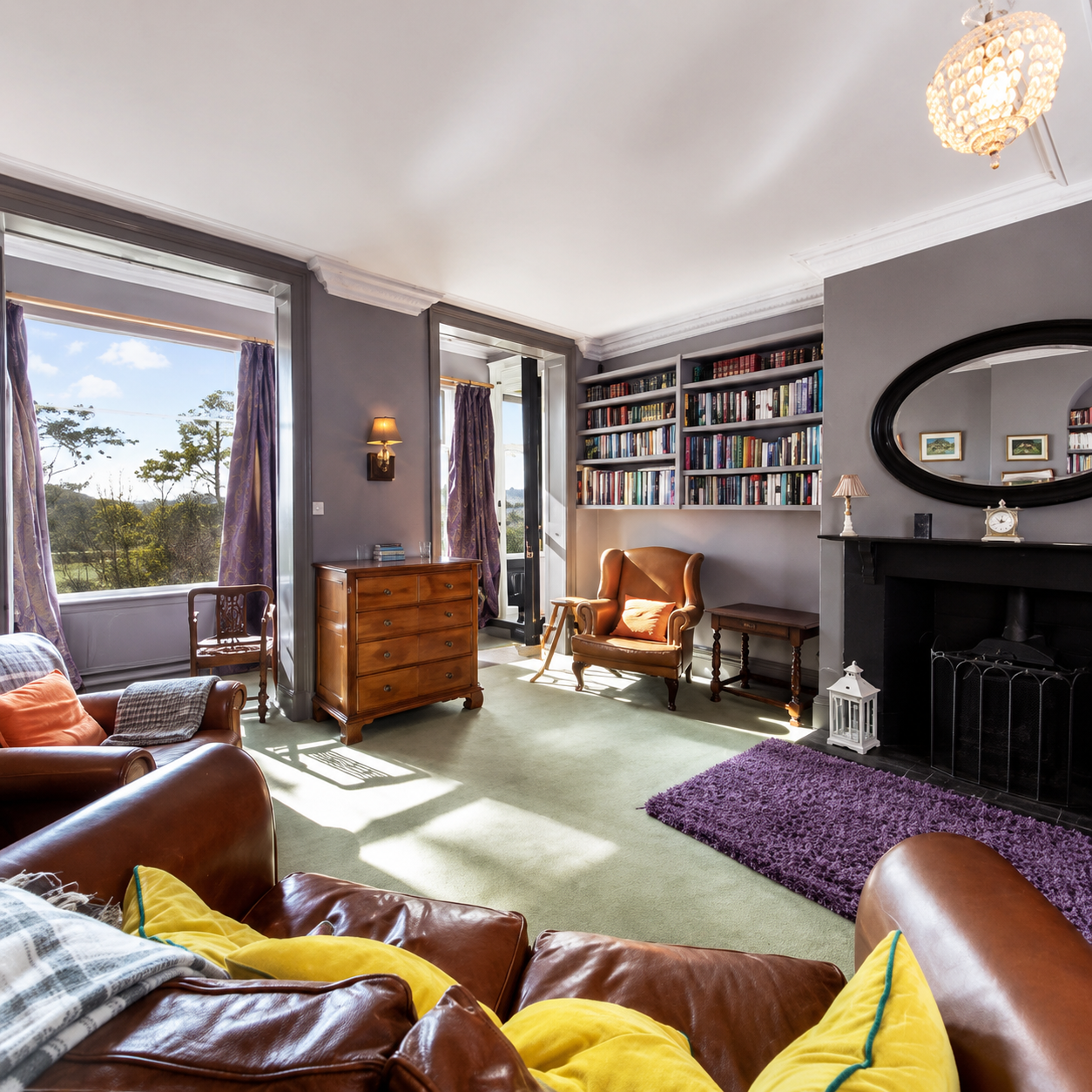 Library sitting room at Heather Brae with leather sofas, fireplace and countryside views